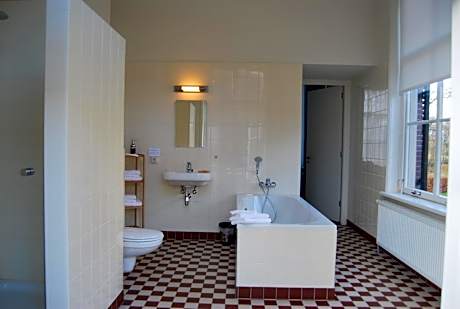 Deluxe kamer - Badkamer met ligbad